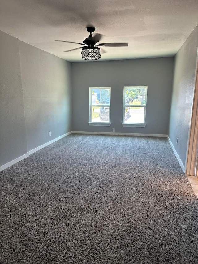 empty room with ceiling fan, carpet, and a textured ceiling