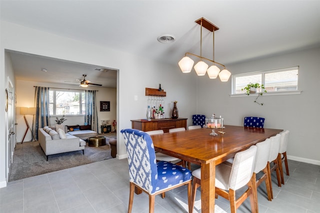 tiled dining area with a wealth of natural light and ceiling fan