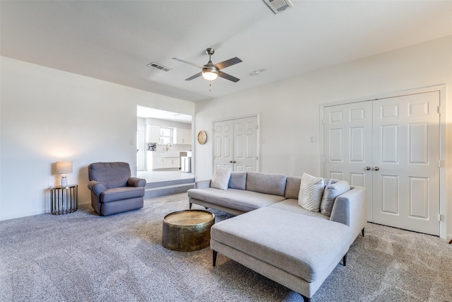 living room with ceiling fan and carpet floors