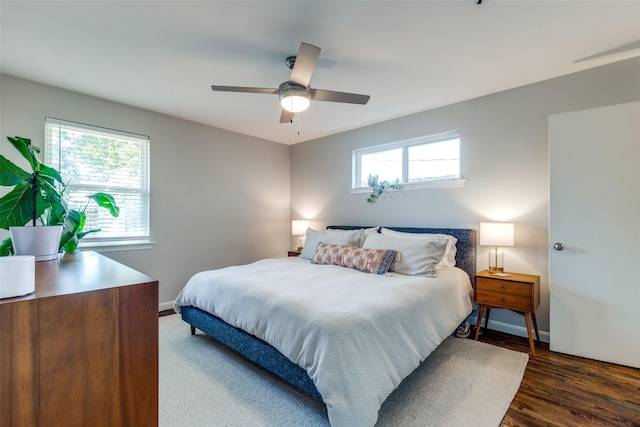 bedroom with ceiling fan and dark hardwood / wood-style flooring