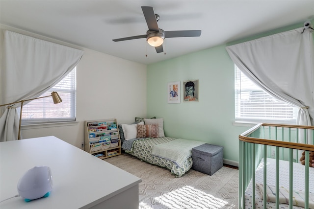 bedroom featuring ceiling fan and multiple windows