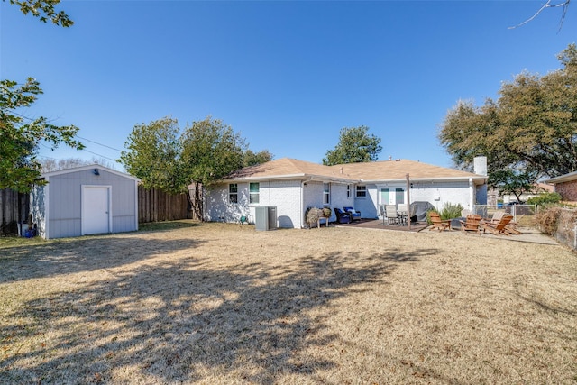 rear view of house with a storage shed, a patio area, and central air condition unit