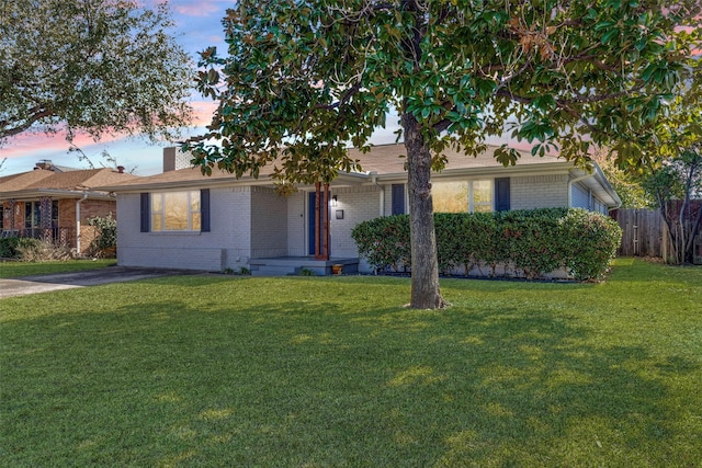 ranch-style home featuring a yard