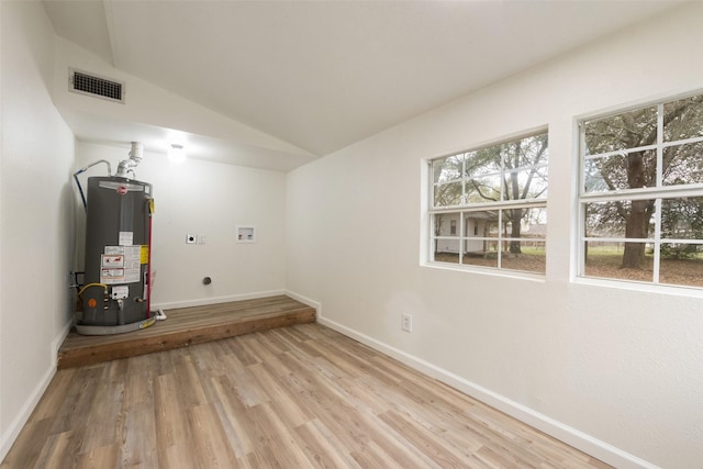 interior space featuring plenty of natural light, electric dryer hookup, hookup for a washing machine, and gas water heater