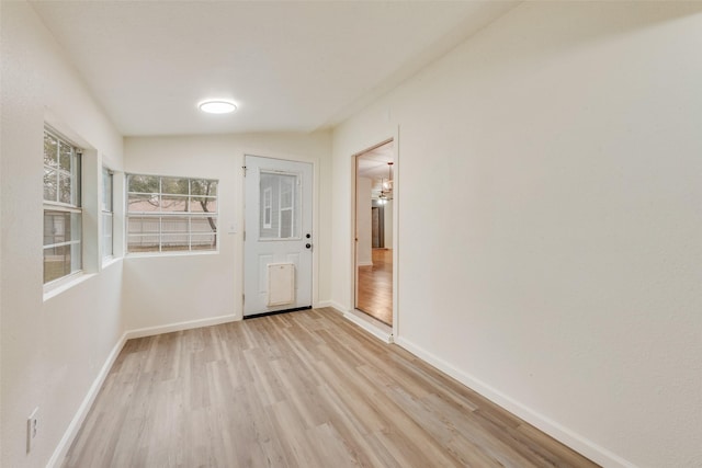 empty room with light hardwood / wood-style flooring