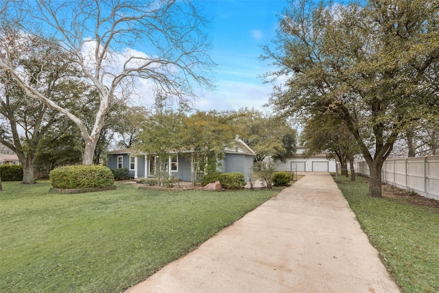 view of front of property with a garage and a front lawn