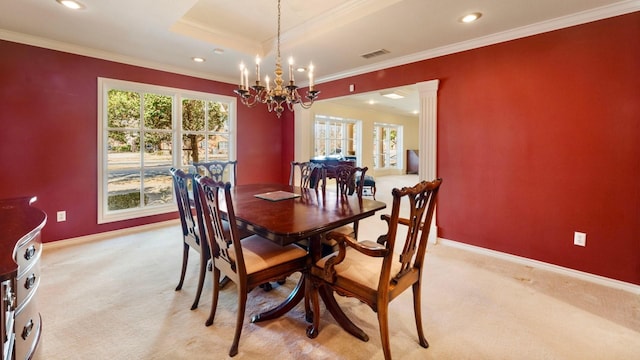 carpeted dining room featuring ornamental molding, a healthy amount of sunlight, and a notable chandelier