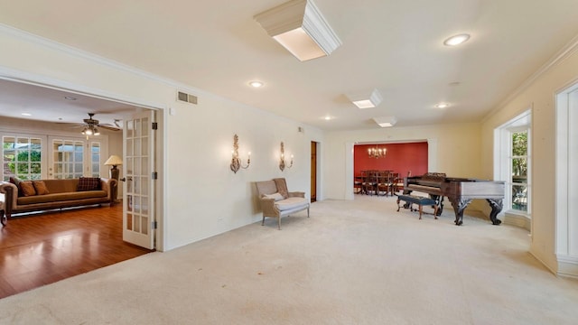 living area with ornamental molding, french doors, and carpet