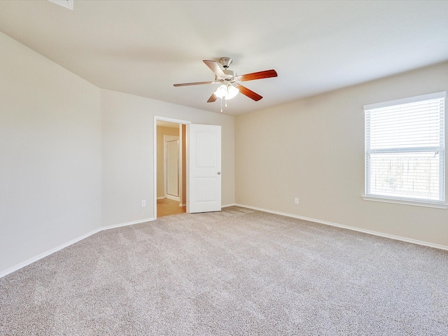 carpeted spare room with ceiling fan