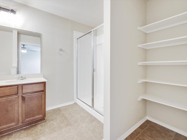 bathroom featuring vanity, tile patterned floors, ceiling fan, and walk in shower