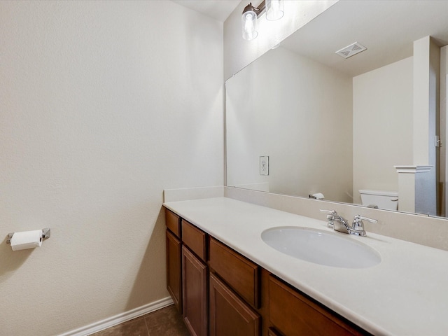 bathroom featuring vanity, toilet, and tile patterned flooring