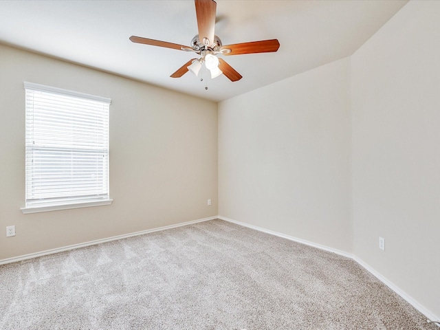 spare room featuring light colored carpet and ceiling fan