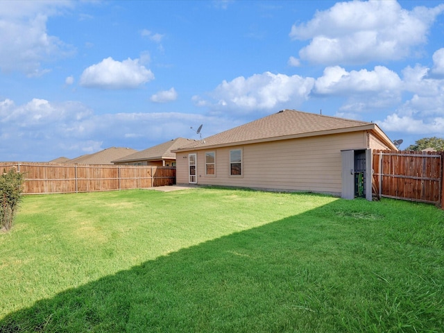 rear view of property with a lawn