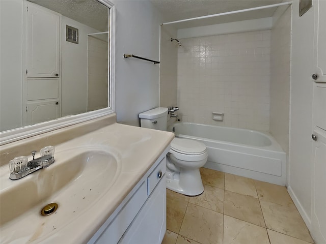 full bathroom featuring tile patterned floors, toilet, tiled shower / bath, a textured ceiling, and vanity