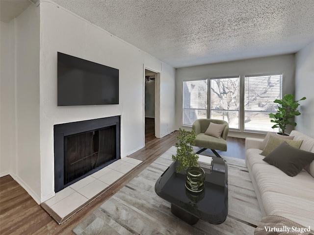 living room with hardwood / wood-style flooring and a textured ceiling