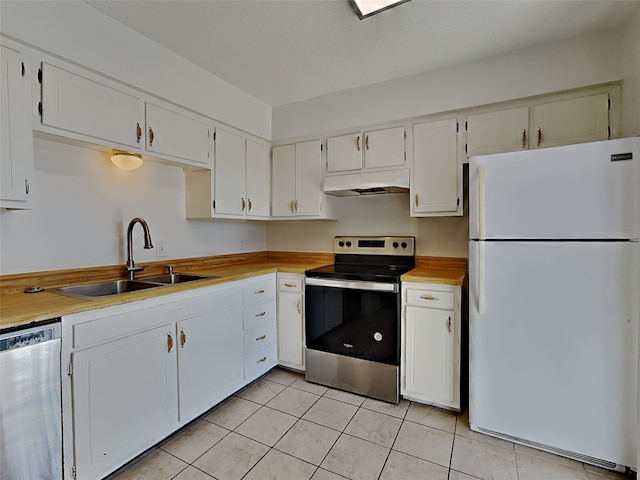 kitchen featuring white cabinetry, appliances with stainless steel finishes, sink, and light tile patterned floors