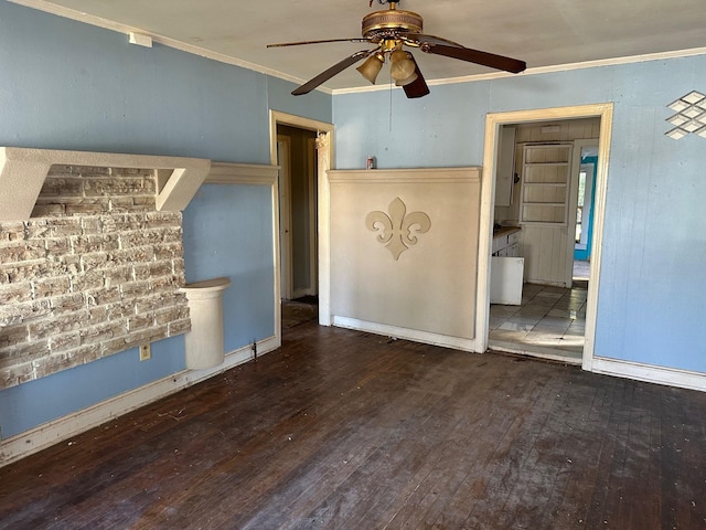 unfurnished living room featuring dark hardwood / wood-style flooring, ornamental molding, and ceiling fan