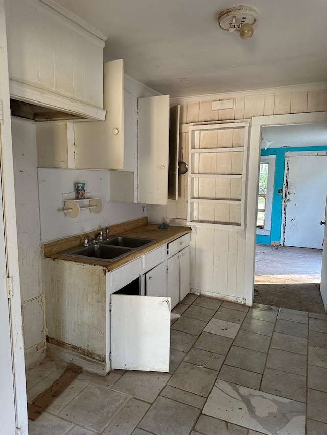 kitchen featuring sink and white cabinets