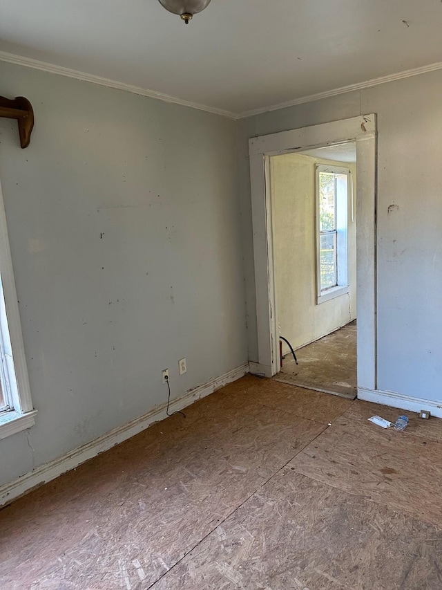 spare room featuring crown molding