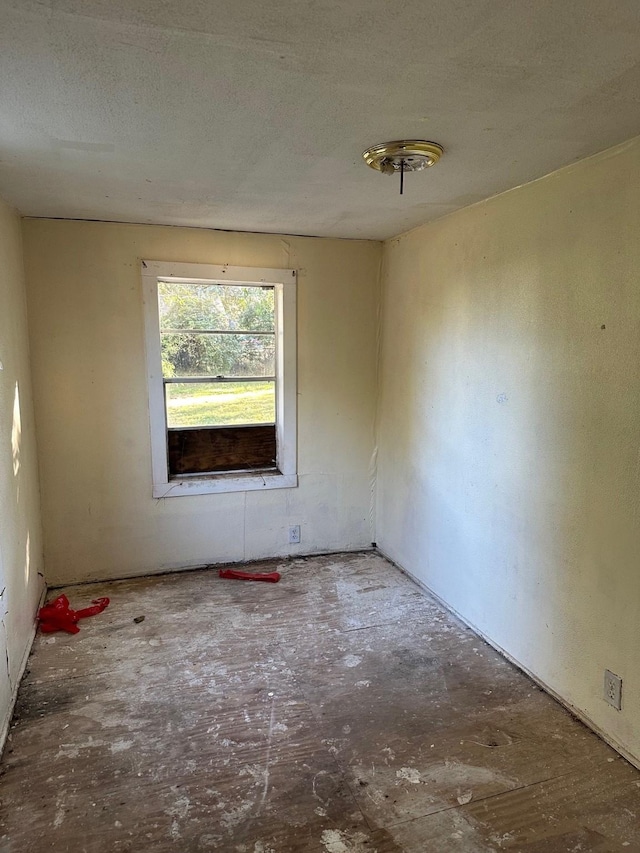 spare room with a textured ceiling