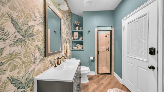 bathroom featuring walk in shower, vanity, toilet, and hardwood / wood-style floors