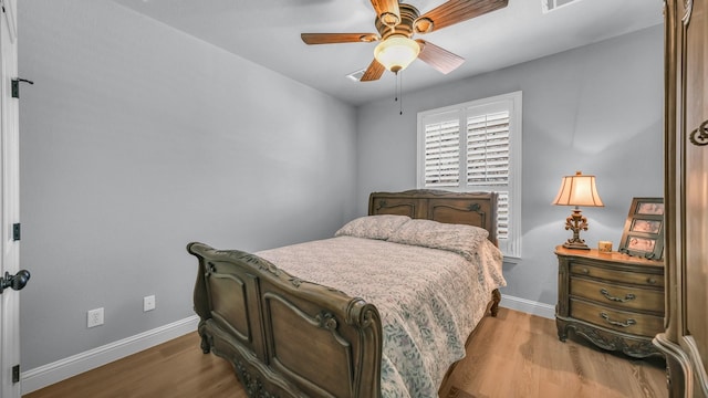 bedroom with light hardwood / wood-style floors and ceiling fan