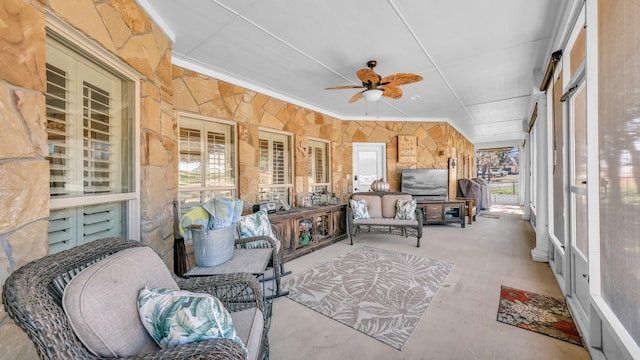 sunroom featuring ceiling fan