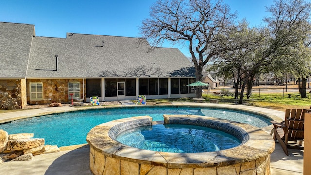 view of pool featuring an in ground hot tub and a sunroom