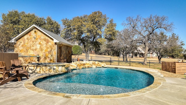 view of pool featuring pool water feature, an in ground hot tub, and a patio area