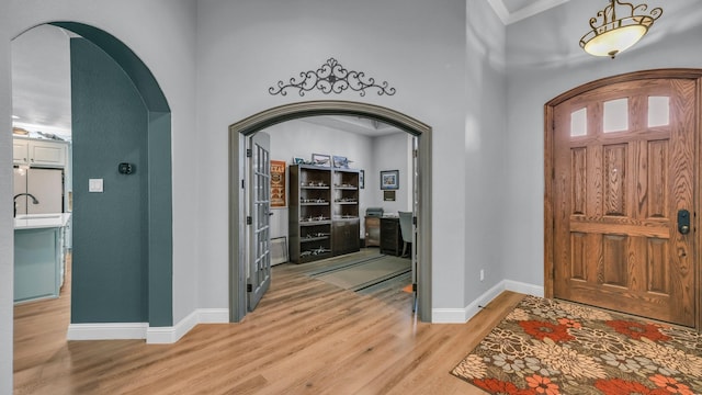 foyer entrance featuring sink and hardwood / wood-style floors