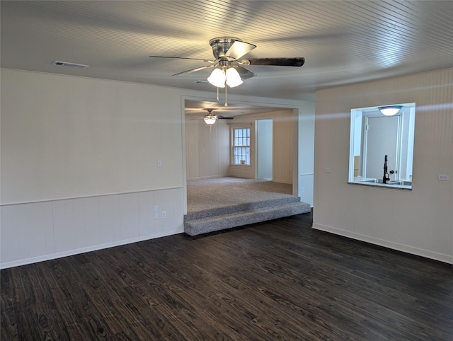 empty room with ceiling fan, dark hardwood / wood-style flooring, and sink