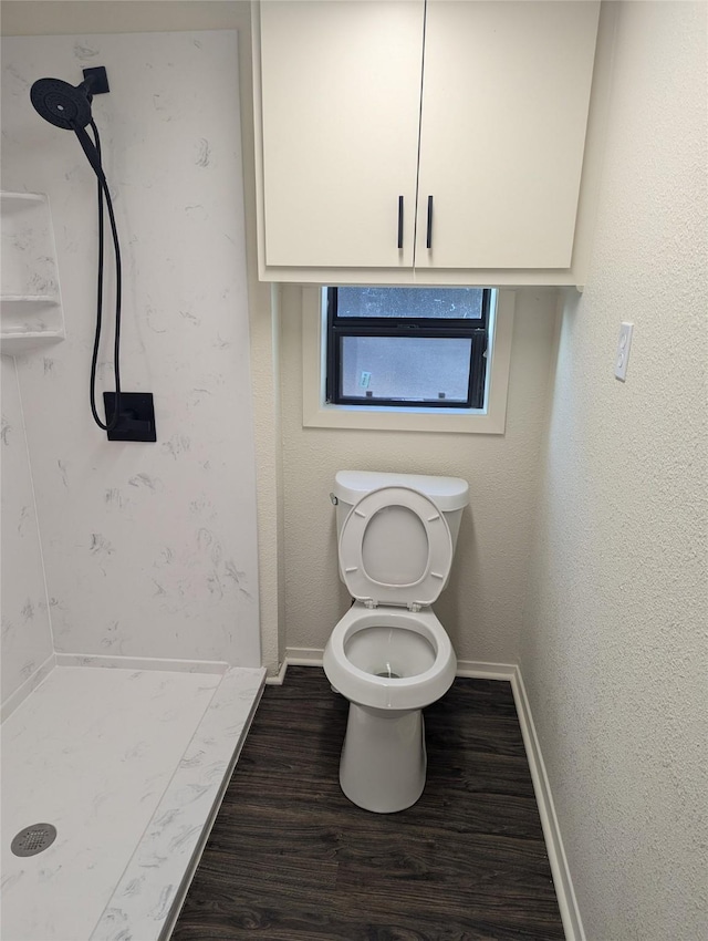 bathroom featuring wood-type flooring, toilet, and walk in shower