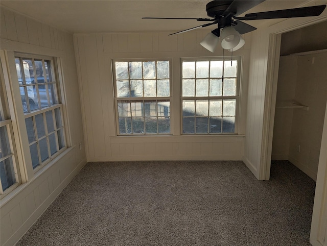 carpeted spare room with ceiling fan