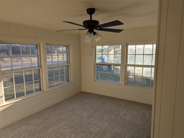 interior space featuring ceiling fan and a textured ceiling