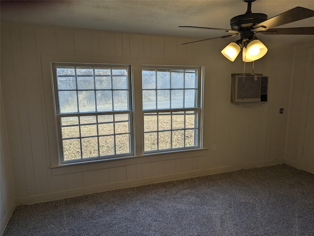 unfurnished room with ceiling fan, carpet, a wall mounted air conditioner, and a textured ceiling