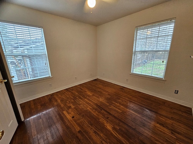 spare room featuring ceiling fan and dark hardwood / wood-style flooring