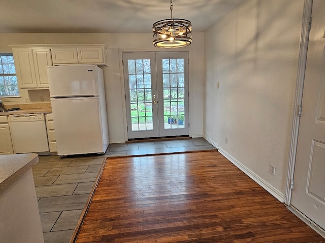 doorway to outside with wood-type flooring, french doors, and a chandelier