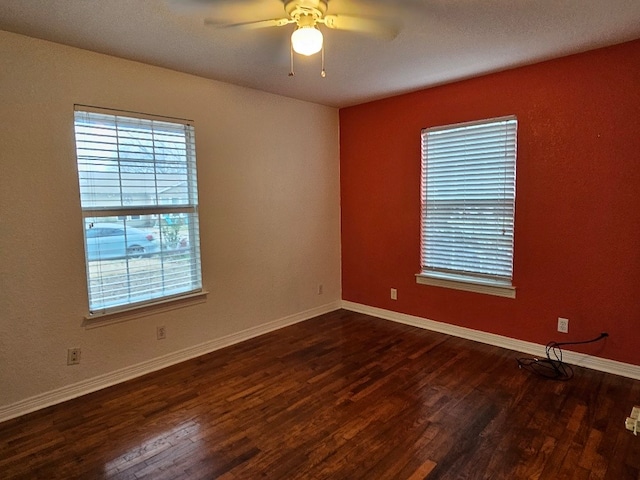 unfurnished room with dark wood-type flooring and ceiling fan