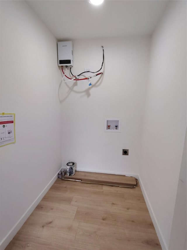 laundry room featuring hookup for a washing machine, light wood-style flooring, laundry area, baseboards, and electric dryer hookup