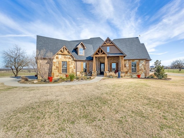 craftsman-style home featuring a front lawn