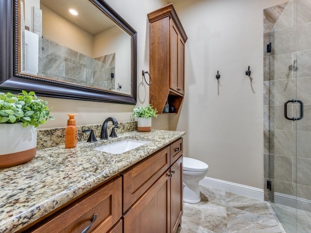 bathroom with vanity, toilet, and a shower with shower door