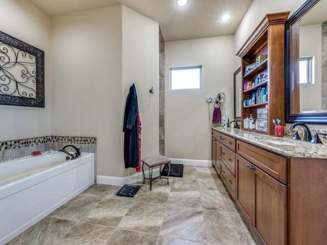 bathroom with vanity and a bath