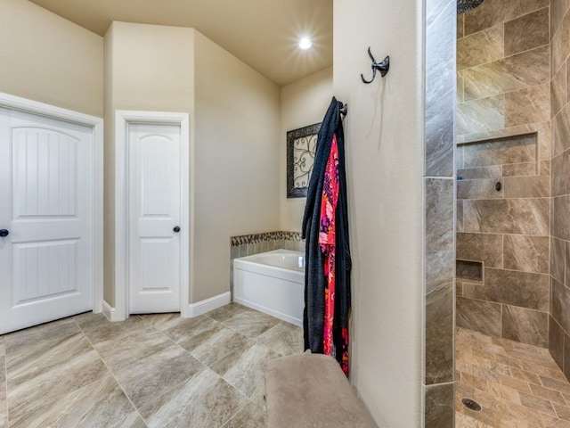 bathroom featuring shower with separate bathtub