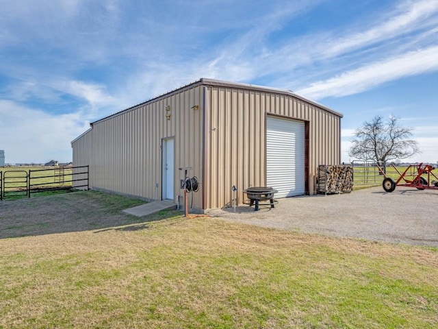 view of outdoor structure featuring a garage and a lawn