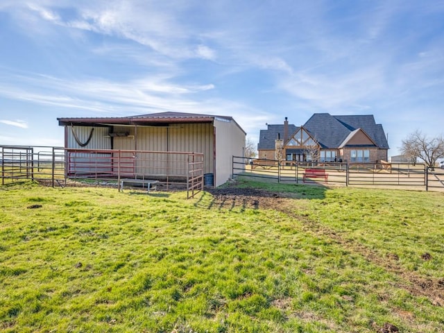 view of yard featuring an outbuilding and a rural view