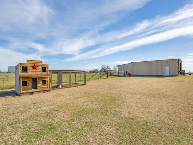 view of yard featuring a rural view and an outdoor structure