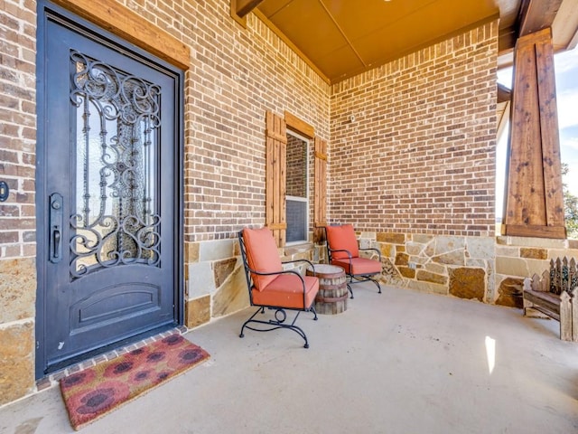 view of exterior entry with covered porch