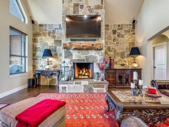 living room featuring a fireplace, high vaulted ceiling, and dark hardwood / wood-style floors