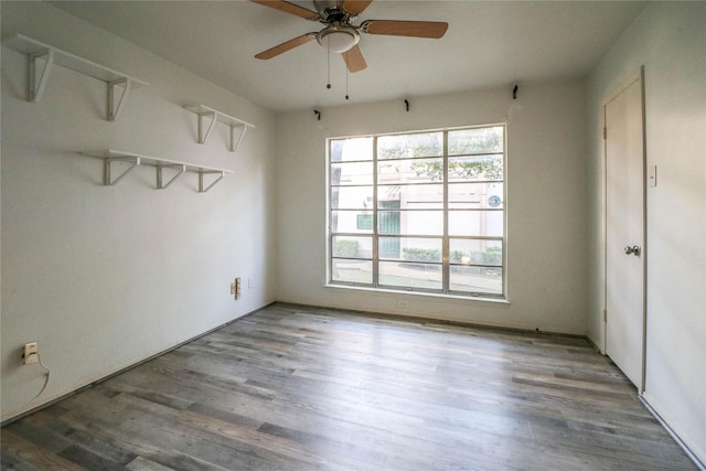 empty room with hardwood / wood-style flooring and ceiling fan