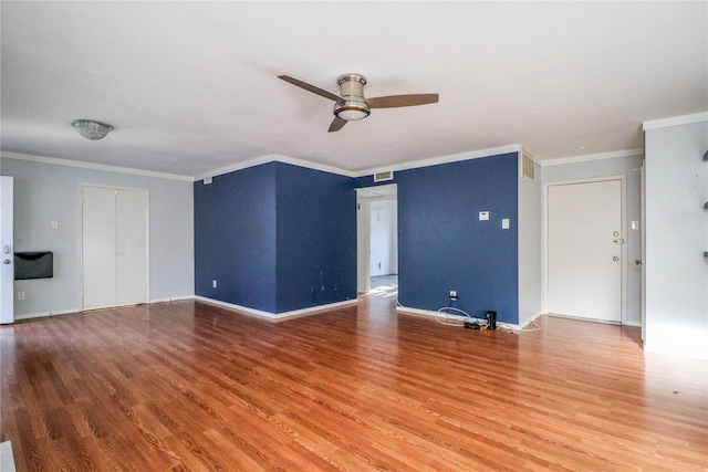 unfurnished living room with wood-type flooring, ornamental molding, and ceiling fan